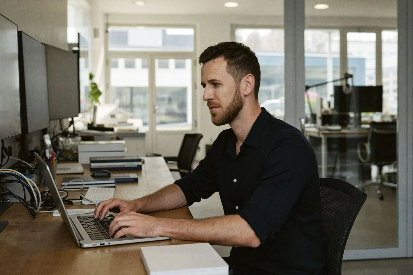 Matthias Isler concentrating on engineering work at a laptop